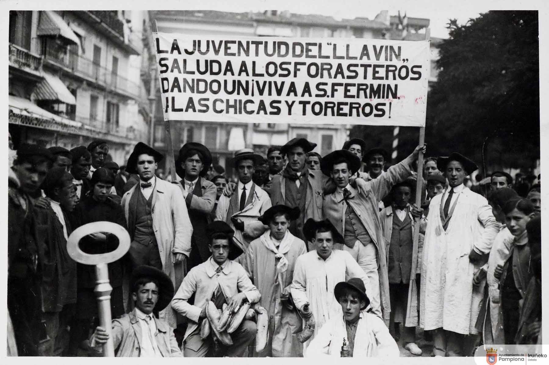 1914. Los ‘Blusas blancas’ o la denominada ‘Juventud del Llavín’ posan con su cartel en la plaza del Castillo. (Foto Roldán, Colección Arazuri, Archivo Municipal U0080415)